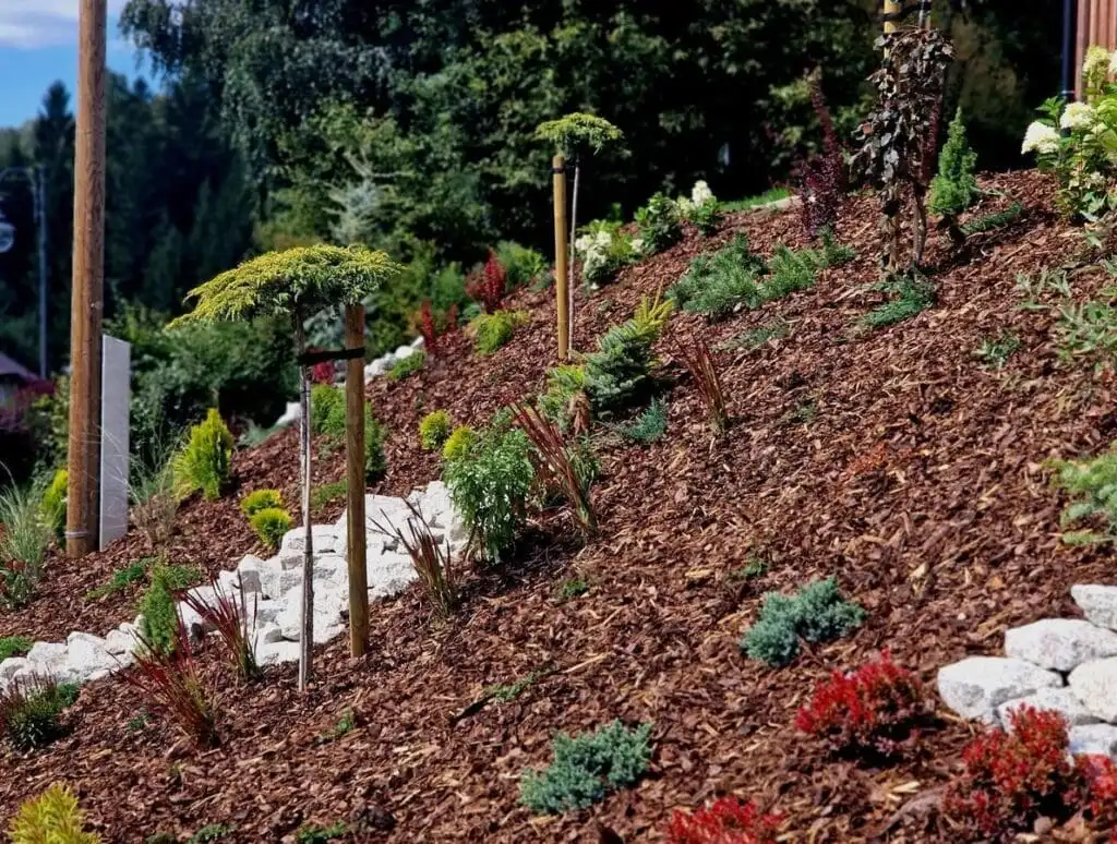 Refreshed mulch bed around a home foundation