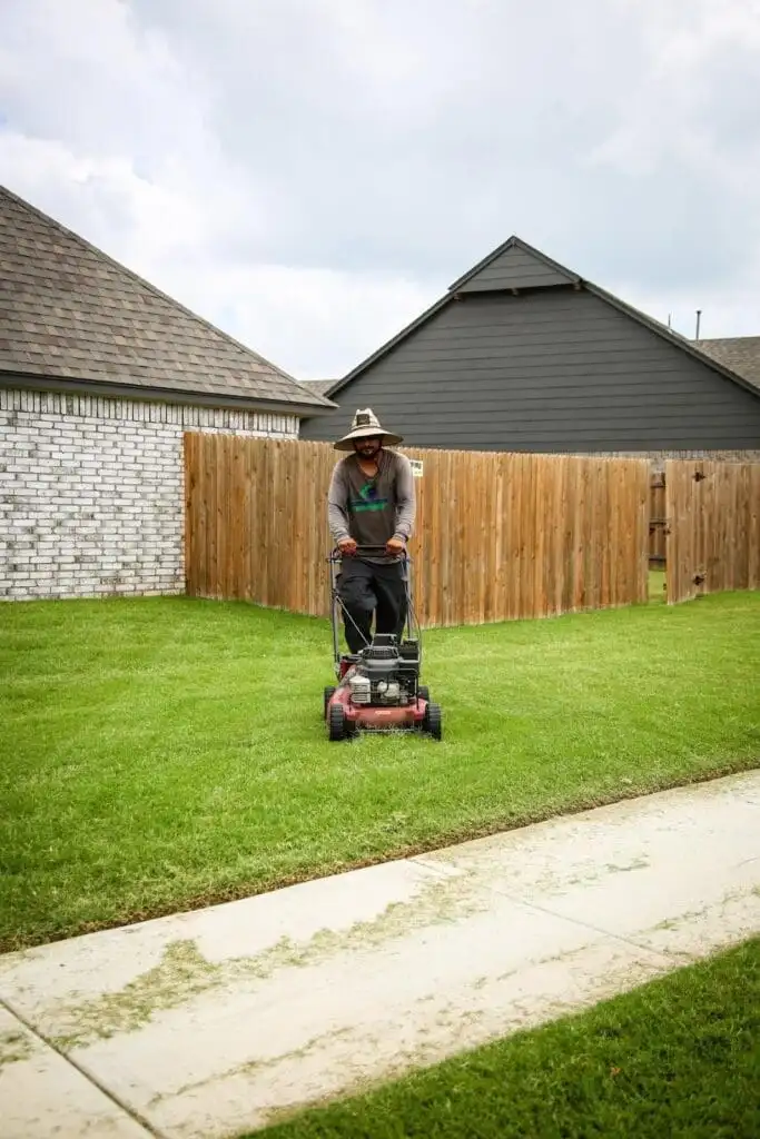 Complete Lawn Care crew maintaining a Tulsa-area backyard at proper seasonal height