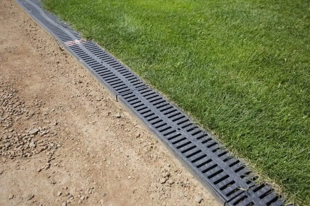 Channel drain trench drain installation at the edge of a lawn