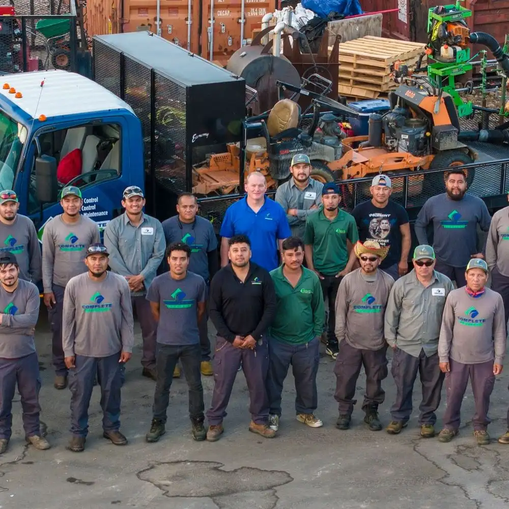 The Complete Lawn Care mowing crew with their trucks and equipment